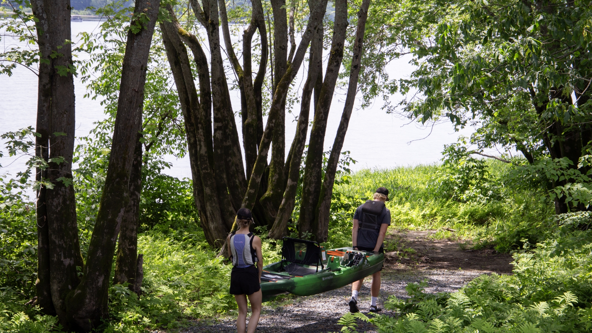 Man and women carrying kayak to the river