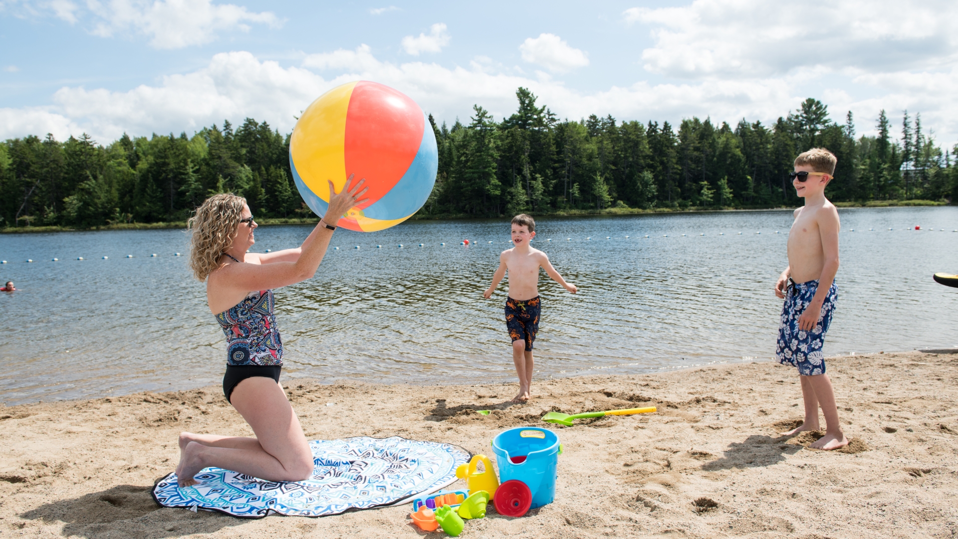 Family playing with ball at the lake