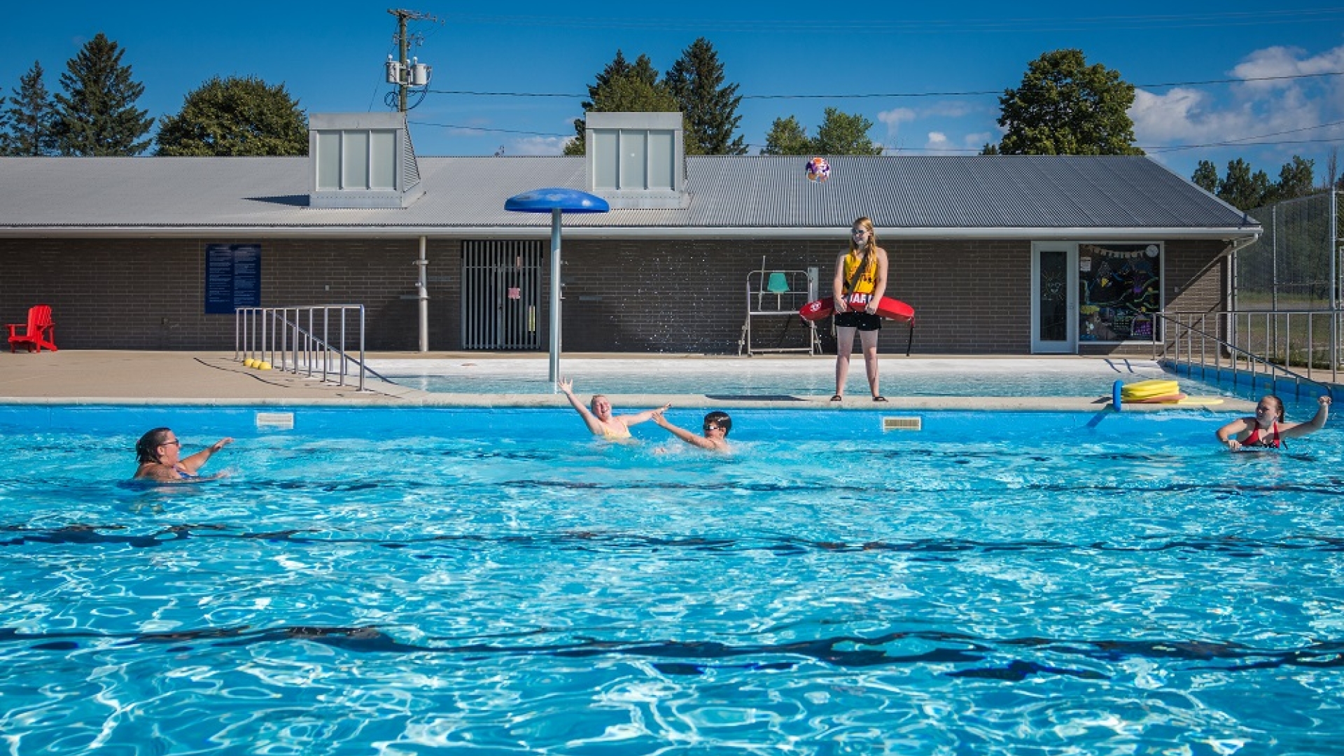 Lifeguard with kids in pool