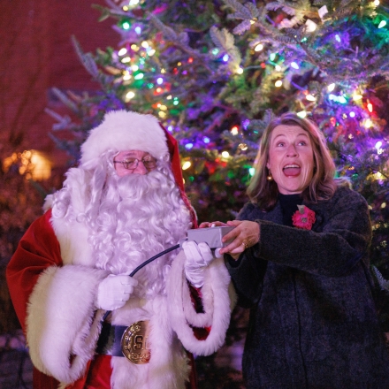 Mayor and santa lighting a christmas tree