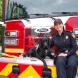  Augie, an 18-month-old black labrador retriever and handler Lieutenant Jennifer Vail. 