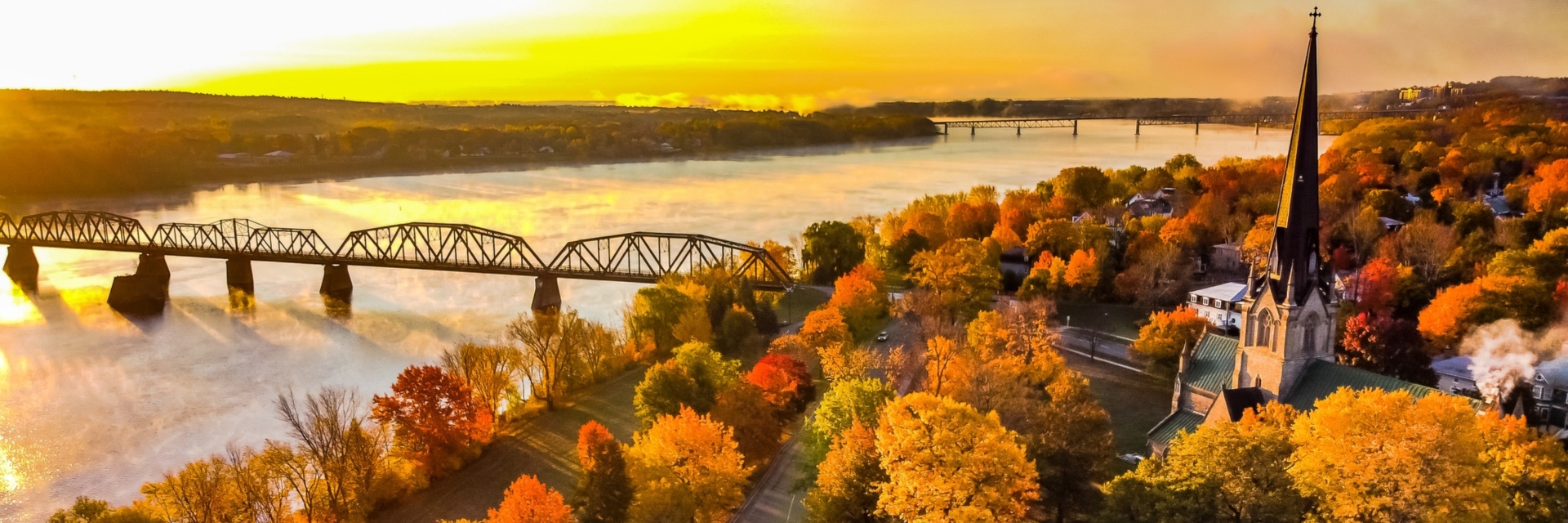 city of Fredericton landscape with bridge and river at sunset during the fall