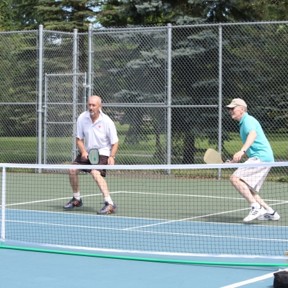 Two men playing pickleball