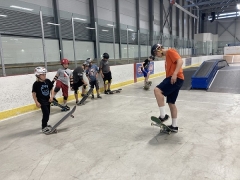 Kids learning to skateboard