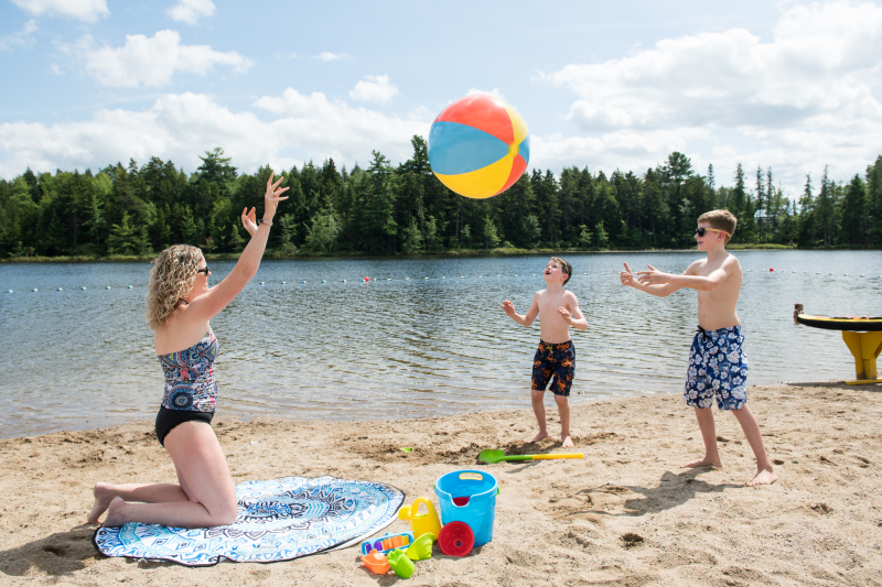 Woman and children playing with beachball at Killarney Beach