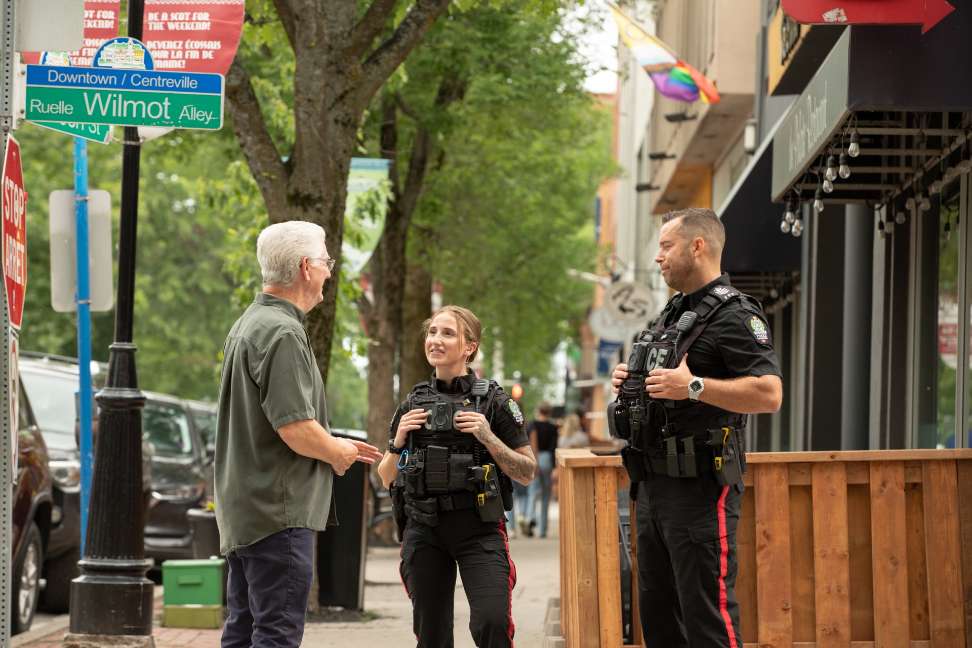 Resident and Police Officers talking in front of business 