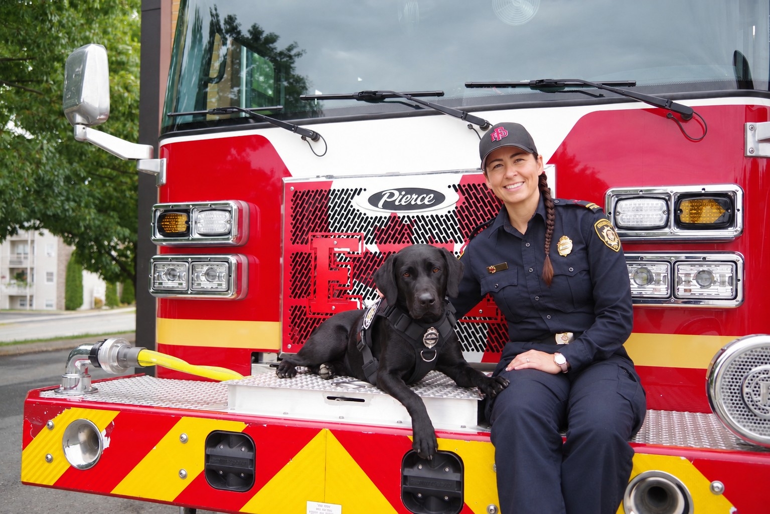  Augie, an 18-month-old black labrador retriever and handler Lieutenant Jennifer Vail. 
